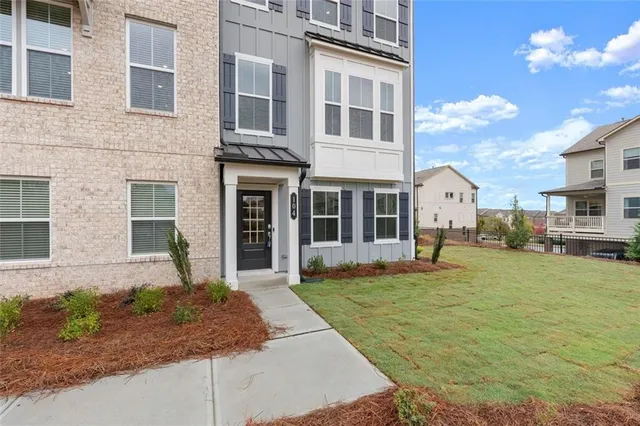 a front view of a house with a yard
