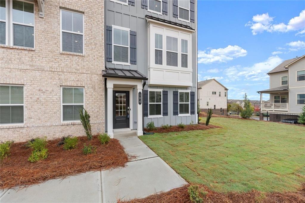 104 Agnew Way Woodstock, GA 30188 - Photo 3 of 47 a front view of a house with a yard