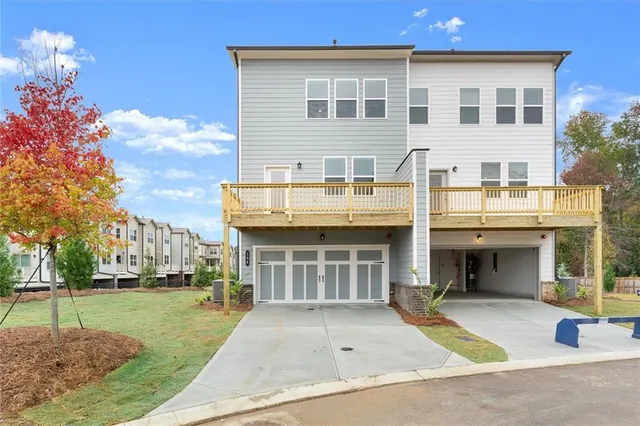 a front view of a house with a yard and potted plants