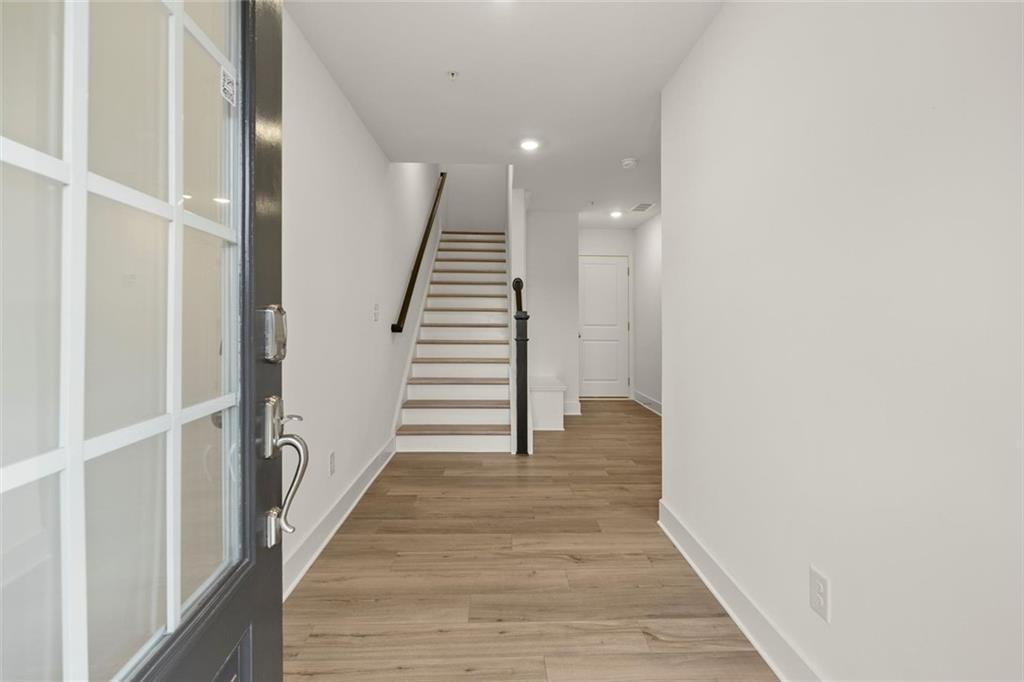 104 Agnew Way Woodstock, GA 30188 - Photo 4 of 47 a view of a hallway with wooden floor and entryway