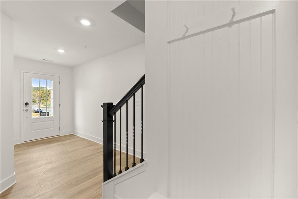 104 Agnew Way Woodstock, GA 30188 - Photo 5 of 47 a view of a hallway with wooden floor and stairs