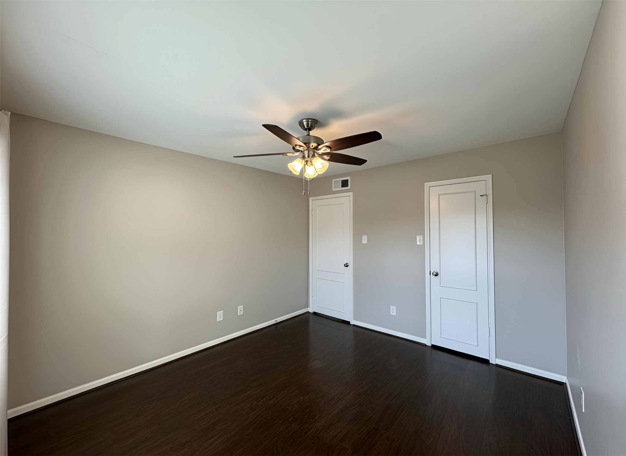 845 Augusta Drive, Unit 90 Houston, TX 77057 - Photo 11 of 17 a view of wooden floor and a chandelier fan in a room