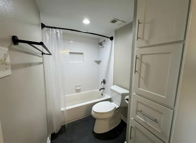 a bathroom with a toilet sink and a shower