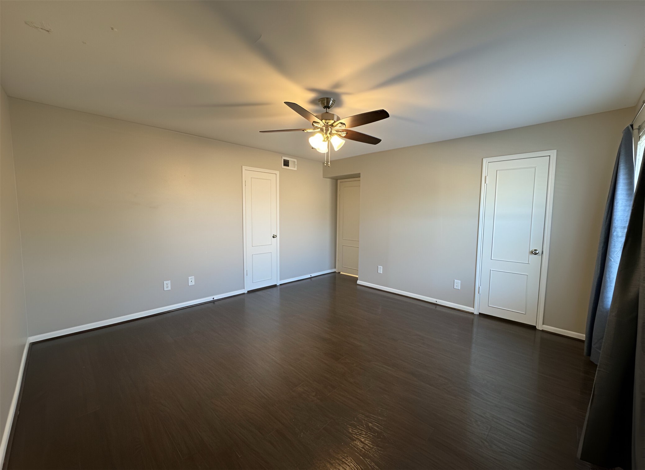 845 Augusta Drive, Unit 90 Houston, TX 77057 - Photo 16 of 17 an empty room with wooden floor and fan