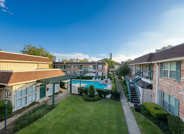 a view of house with a yard and deck