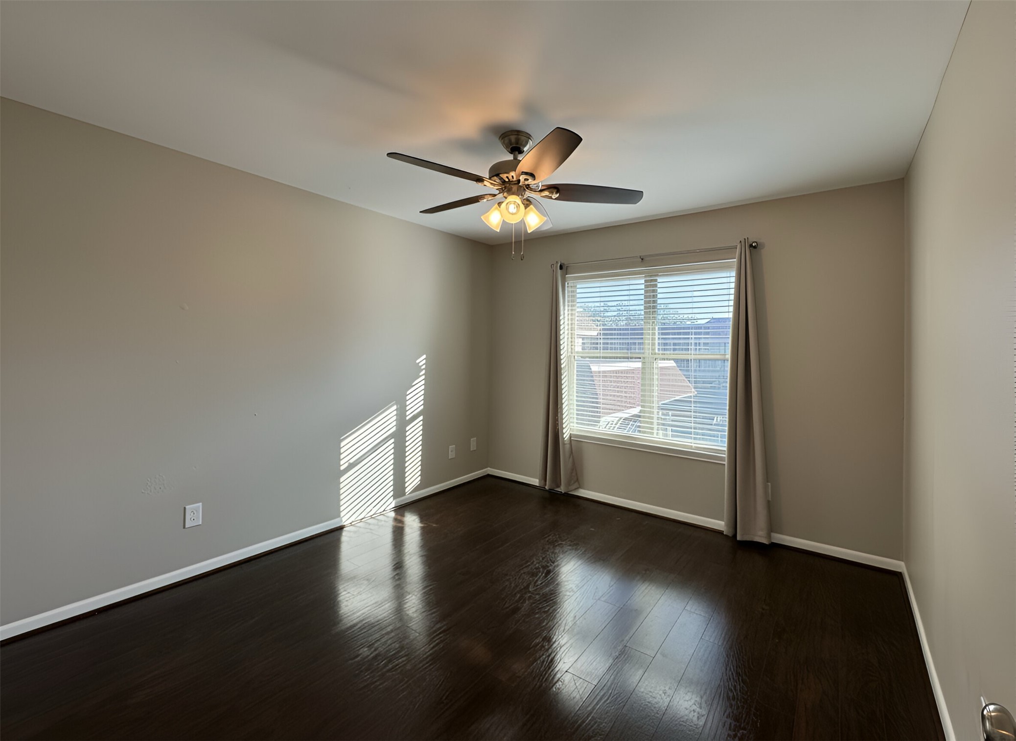 845 Augusta Drive, Unit 90 Houston, TX 77057 - Photo 9 of 17 a view of empty room with wooden floor and fan