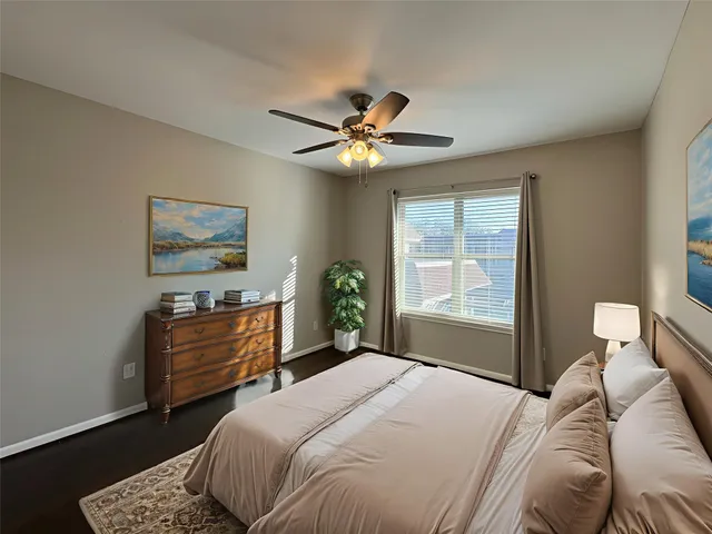 a bedroom with a bed dresser and a window