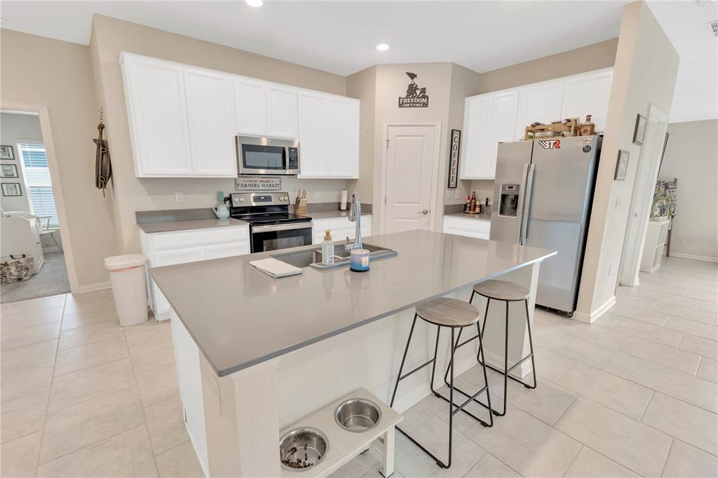 530 Patton Loop Bartow, FL 33830 - Photo 15 of 38 a kitchen with stainless steel appliances a stove a sink a microwave a refrigerator a counter top space and cabinets