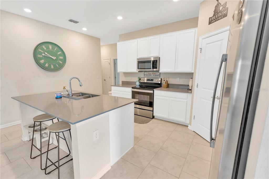 530 Patton Loop Bartow, FL 33830 - Photo 16 of 38 a kitchen with stainless steel appliances a sink a stove a refrigerator and cabinets