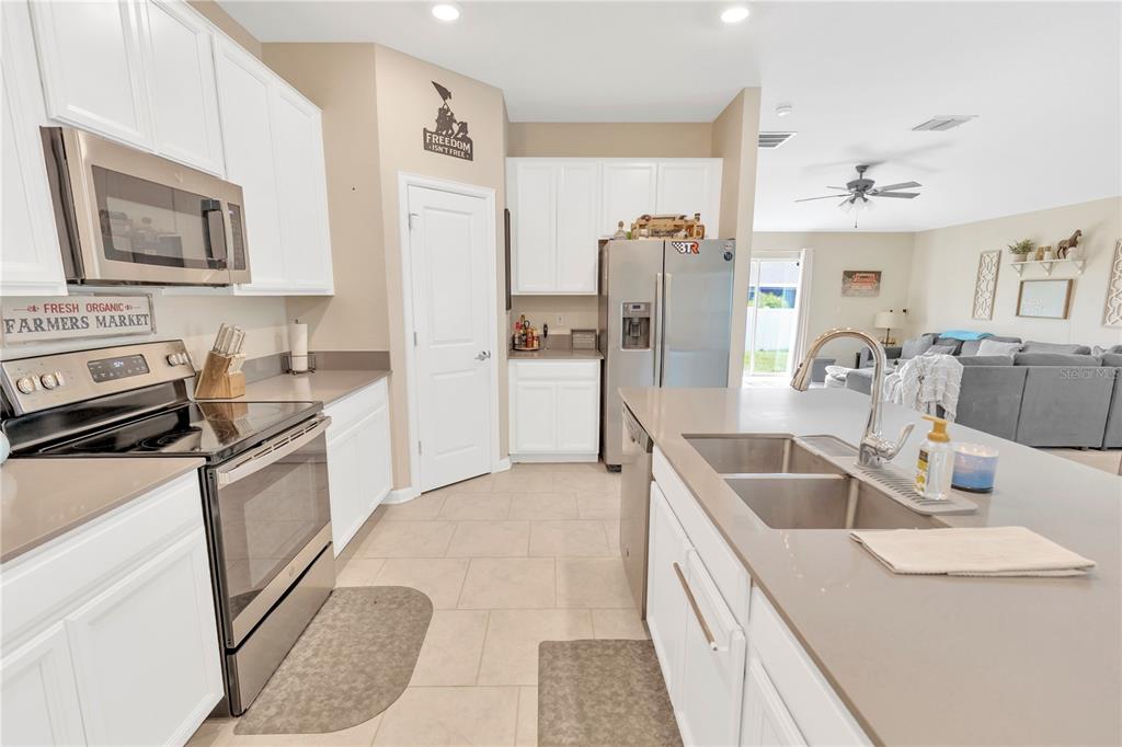 530 Patton Loop Bartow, FL 33830 - Photo 17 of 38 a kitchen with stainless steel appliances granite countertop a sink stove and refrigerator