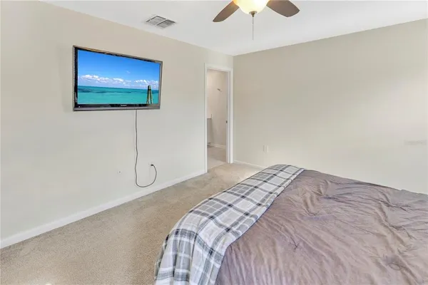 a bedroom with a bed and a flat screen tv
