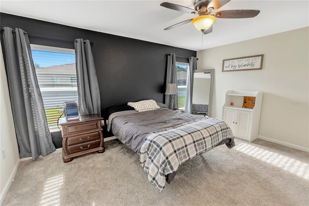 530 Patton Loop Bartow, FL 33830 - Photo 30 of 38 a bedroom with a bed and a chandelier