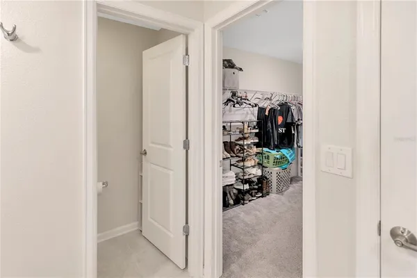 a view of a hallway with white walls and toys