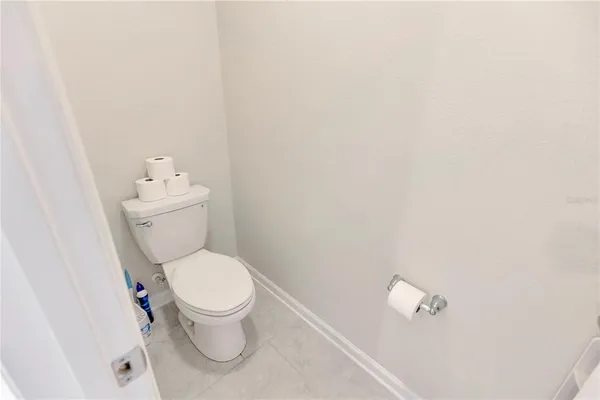 a white toilet sitting next to a white cabinet