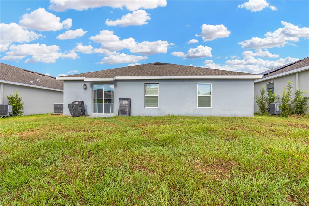 530 Patton Loop Bartow, FL 33830 - Photo 5 of 38 a backyard of a house with table and chairs plants and large tree