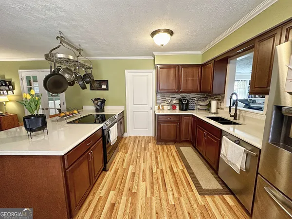 a kitchen with a sink appliances and cabinets