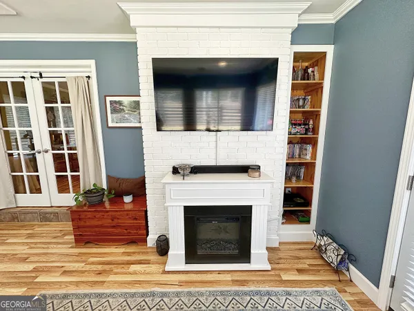 a living room with a fireplace and a rug