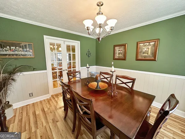 a view of a dining room with furniture and chandelier