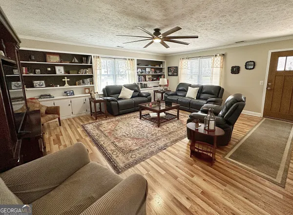 a living room with furniture a rug and a window