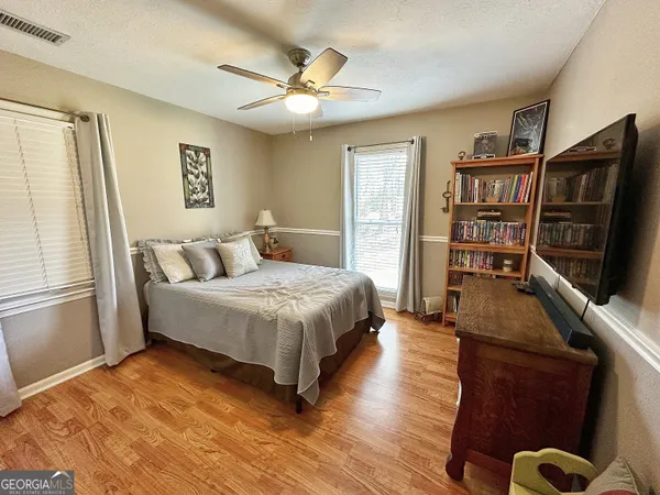 a bedroom with a bed and a flat screen television
