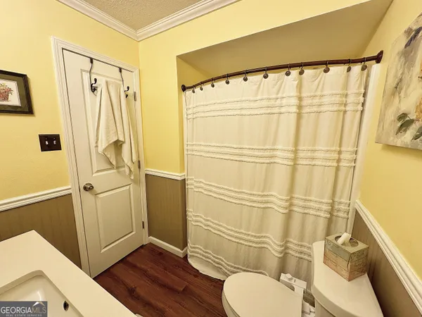 a bathroom with a shower toilet and sink