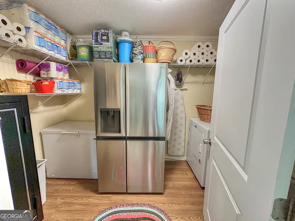 a view of a patio with a table and chairs under an umbrella