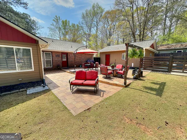 a patio with a table and chairs under an umbrella
