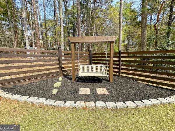 a view of house with backyard and tree