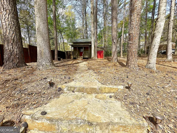 a view of a house with backyard and sitting area