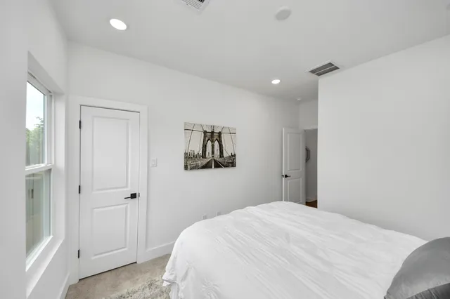 a bedroom with a bed and wall painting