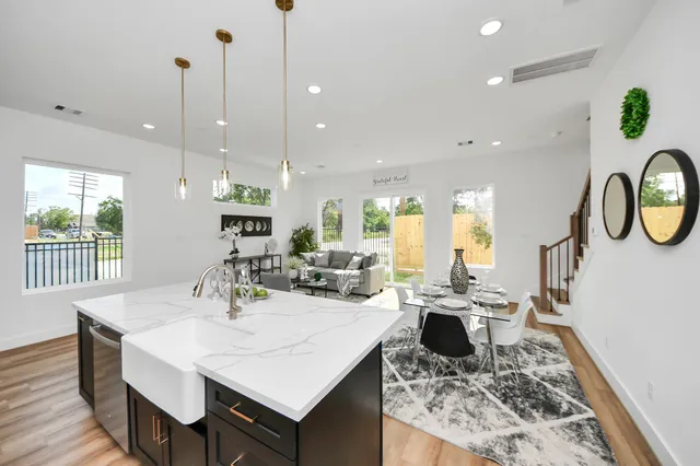 a large kitchen with a table and chairs