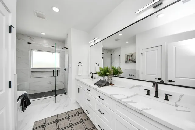 a bathroom with a double vanity sink and a mirror