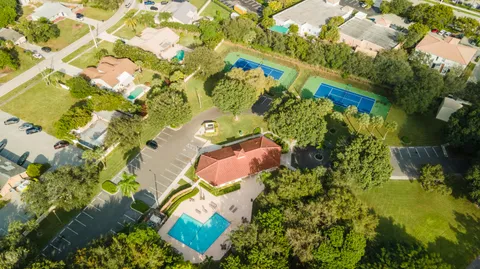 an aerial view of lake and residential houses with outdoor space