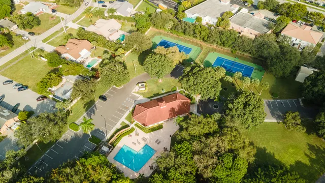 an aerial view of lake and residential houses with outdoor space