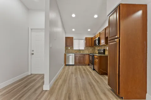 a kitchen with stainless steel appliances granite countertop a refrigerator sink and cabinets