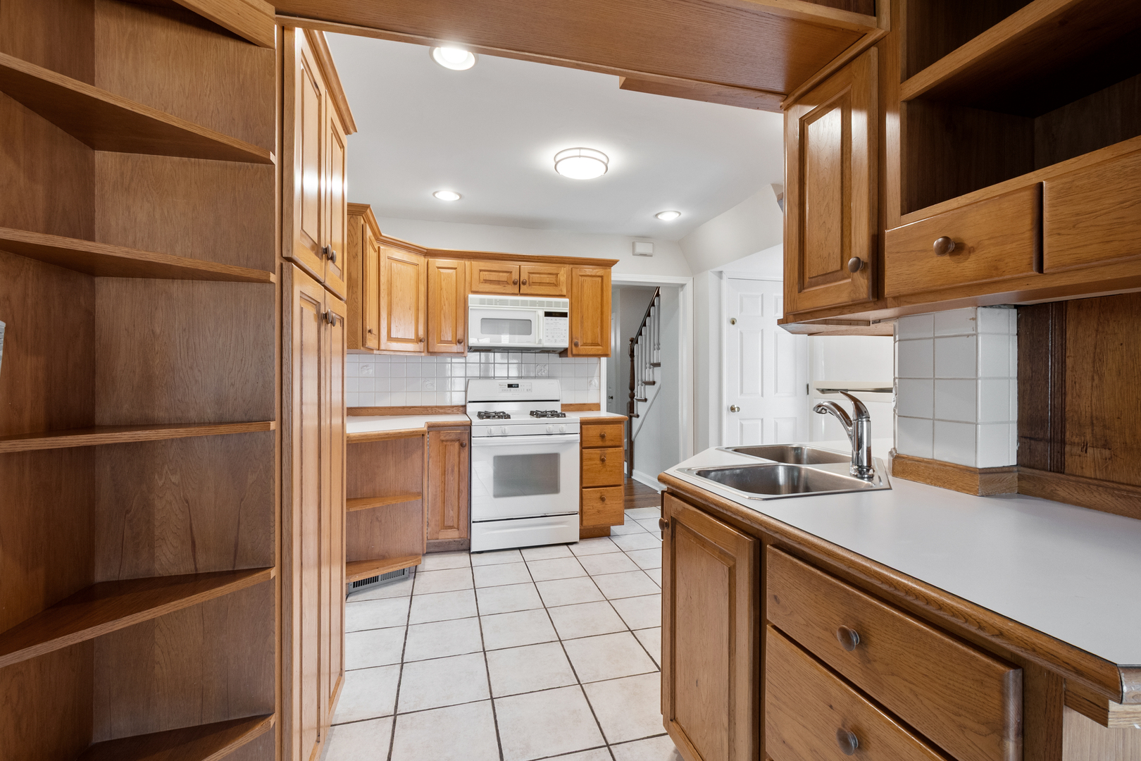 103 North Home Avenue Park Ridge, IL 60068 - Photo 11 of 28 a kitchen with white cabinets and stainless steel appliances