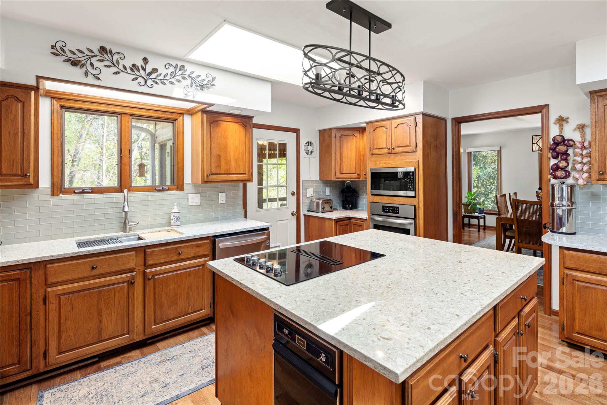 119 Rome Court Lake Lure, NC 28746 - Photo 11 of 31 a kitchen with kitchen island granite countertop a sink and cabinets