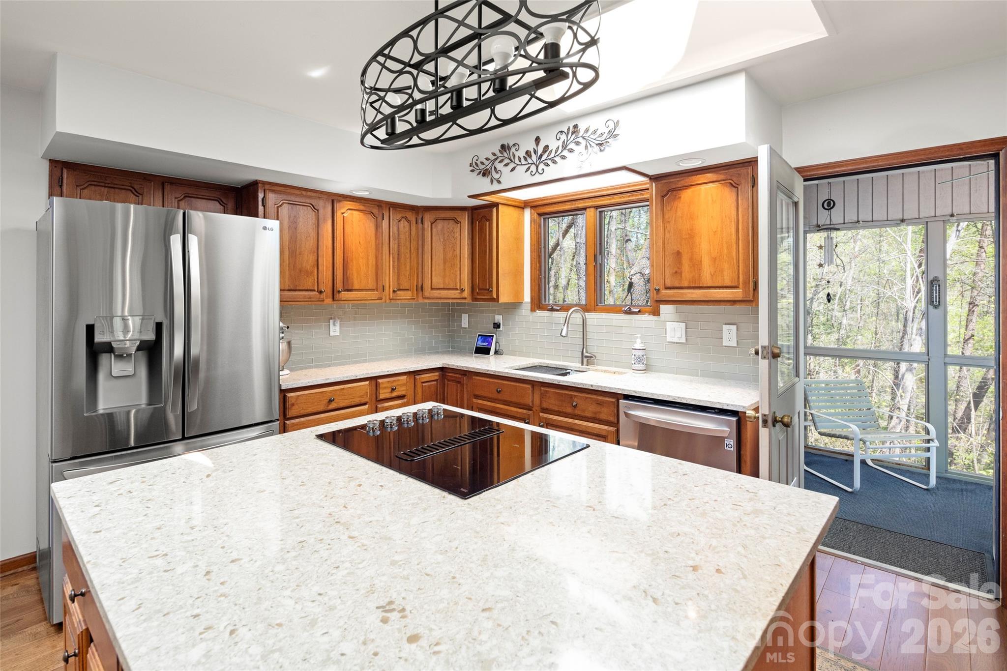 119 Rome Court Lake Lure, NC 28746 - Photo 13 of 31 a kitchen with a refrigerator a sink and cabinets