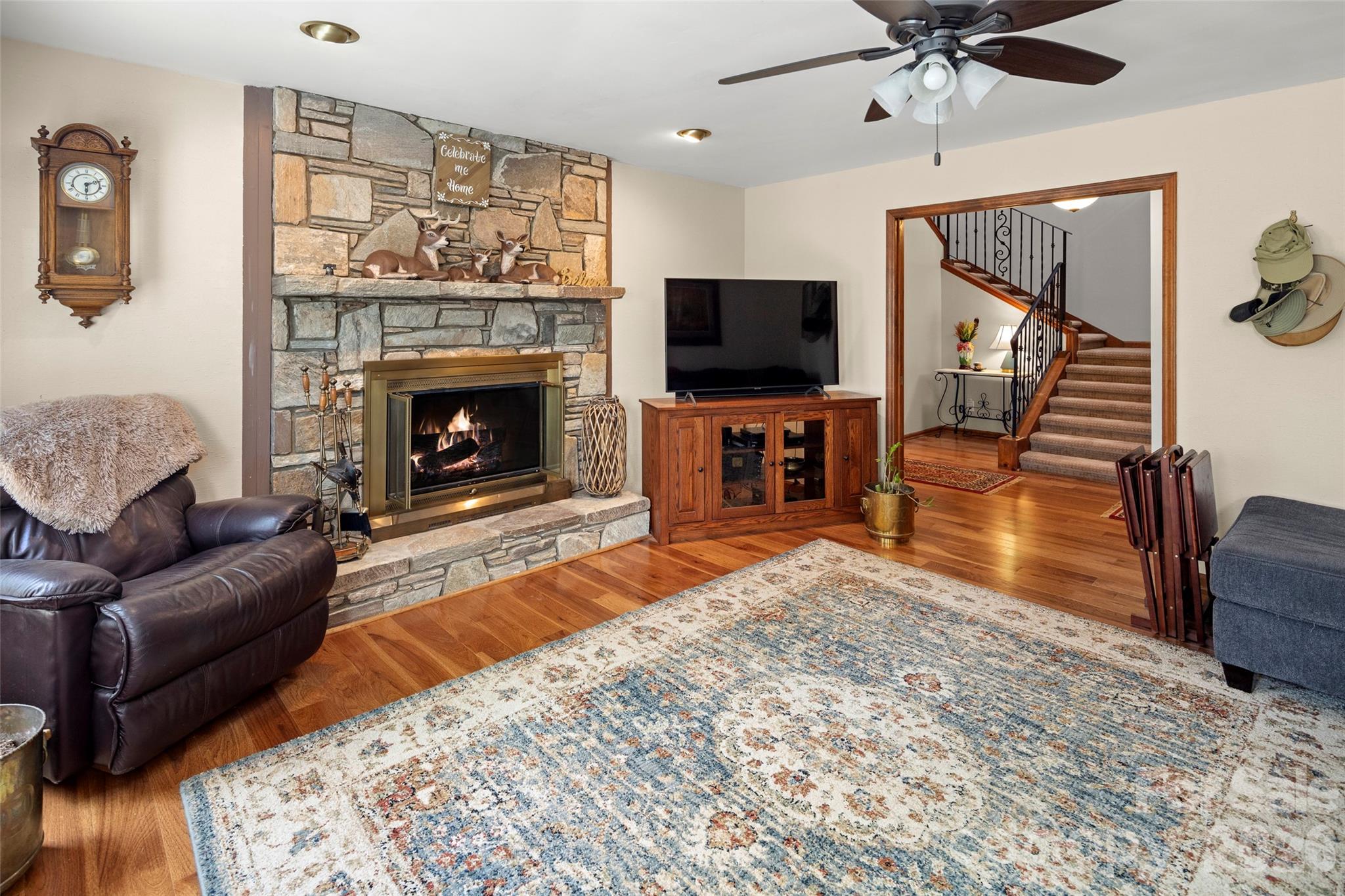 119 Rome Court Lake Lure, NC 28746 - Photo 25 of 31 a living room with furniture a flat screen tv and a fireplace