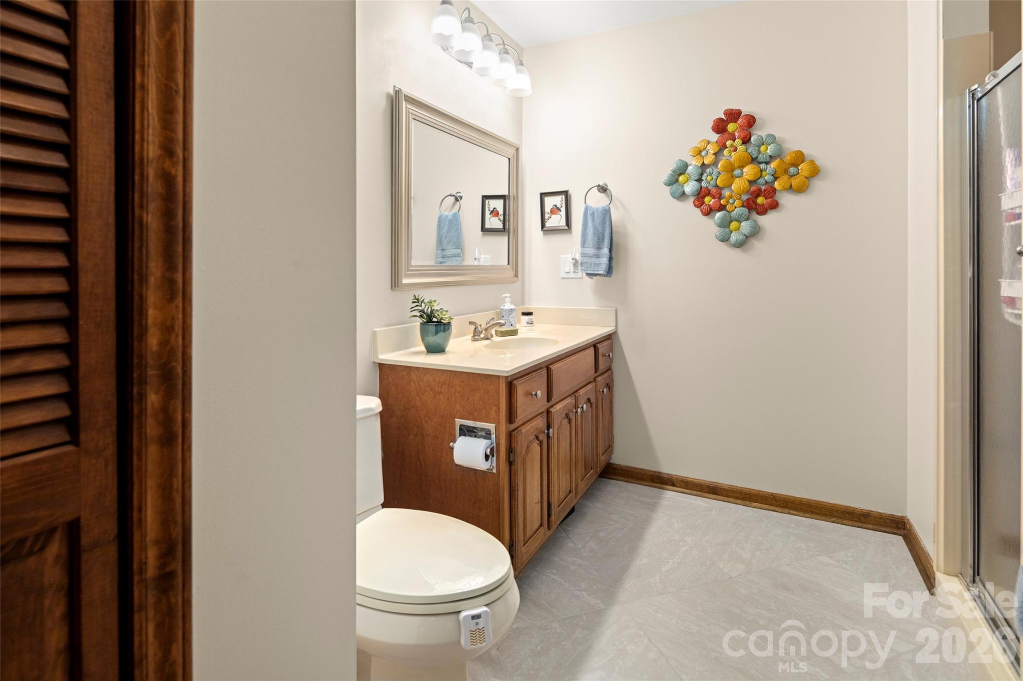 119 Rome Court Lake Lure, NC 28746 - Photo 27 of 31 a bathroom with a sink mirror vanity and toilet