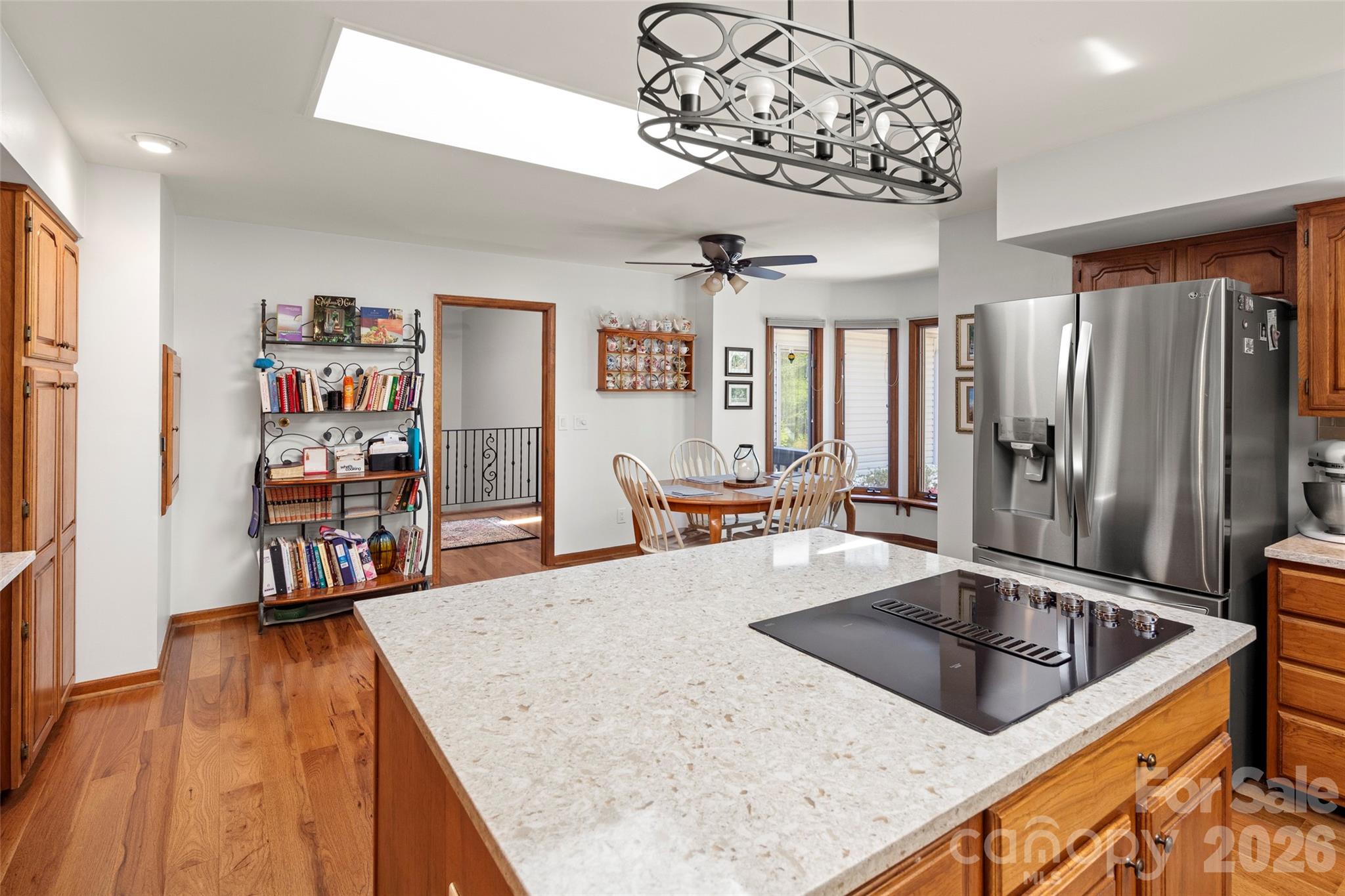 119 Rome Court Lake Lure, NC 28746 - Photo 9 of 31 a kitchen with stainless steel appliances granite countertop a sink dishwasher and a stove with wooden floor