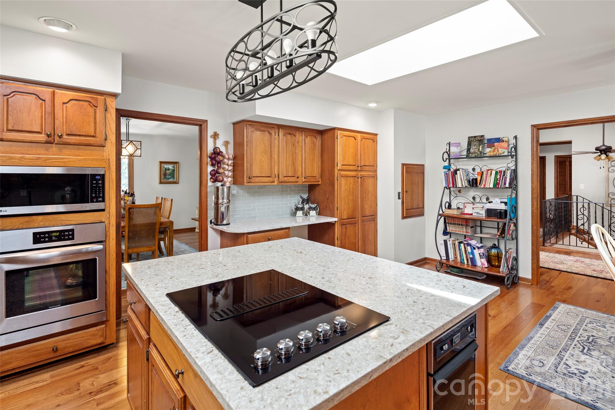119 Rome Court Lake Lure, NC 28746 - Photo 10 of 31 a kitchen with stainless steel appliances granite countertop a stove top oven a sink dishwasher and cabinets with wooden floor
