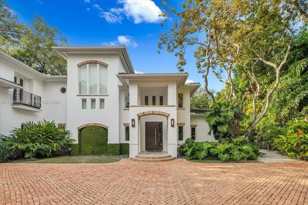a front view of a house with a garden