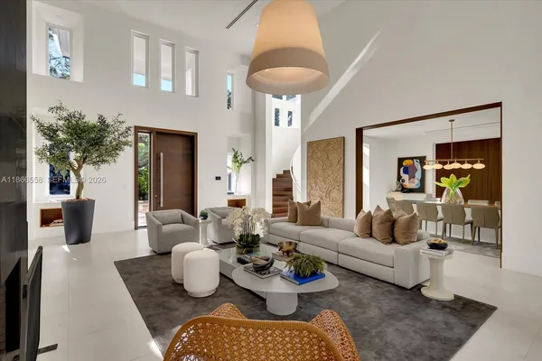 a living room with furniture and a chandelier