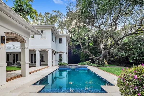 a view of a house with swimming pool and sitting area