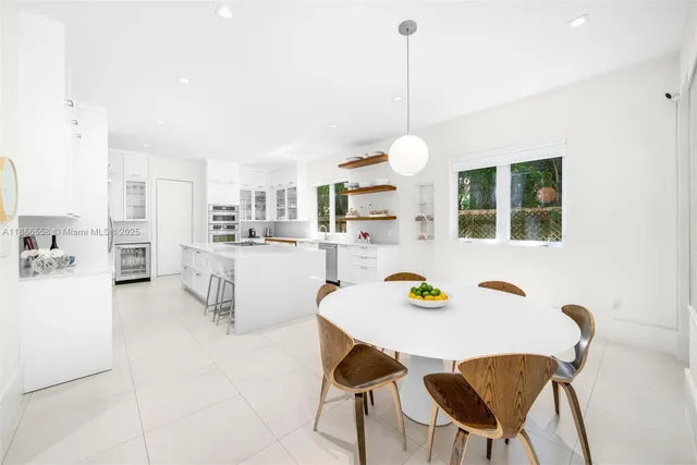 a view of a dining room and a table and chairs in the kitchen