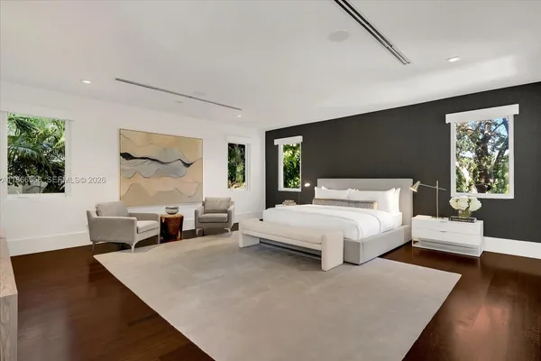 a bed room with a bed and a large window