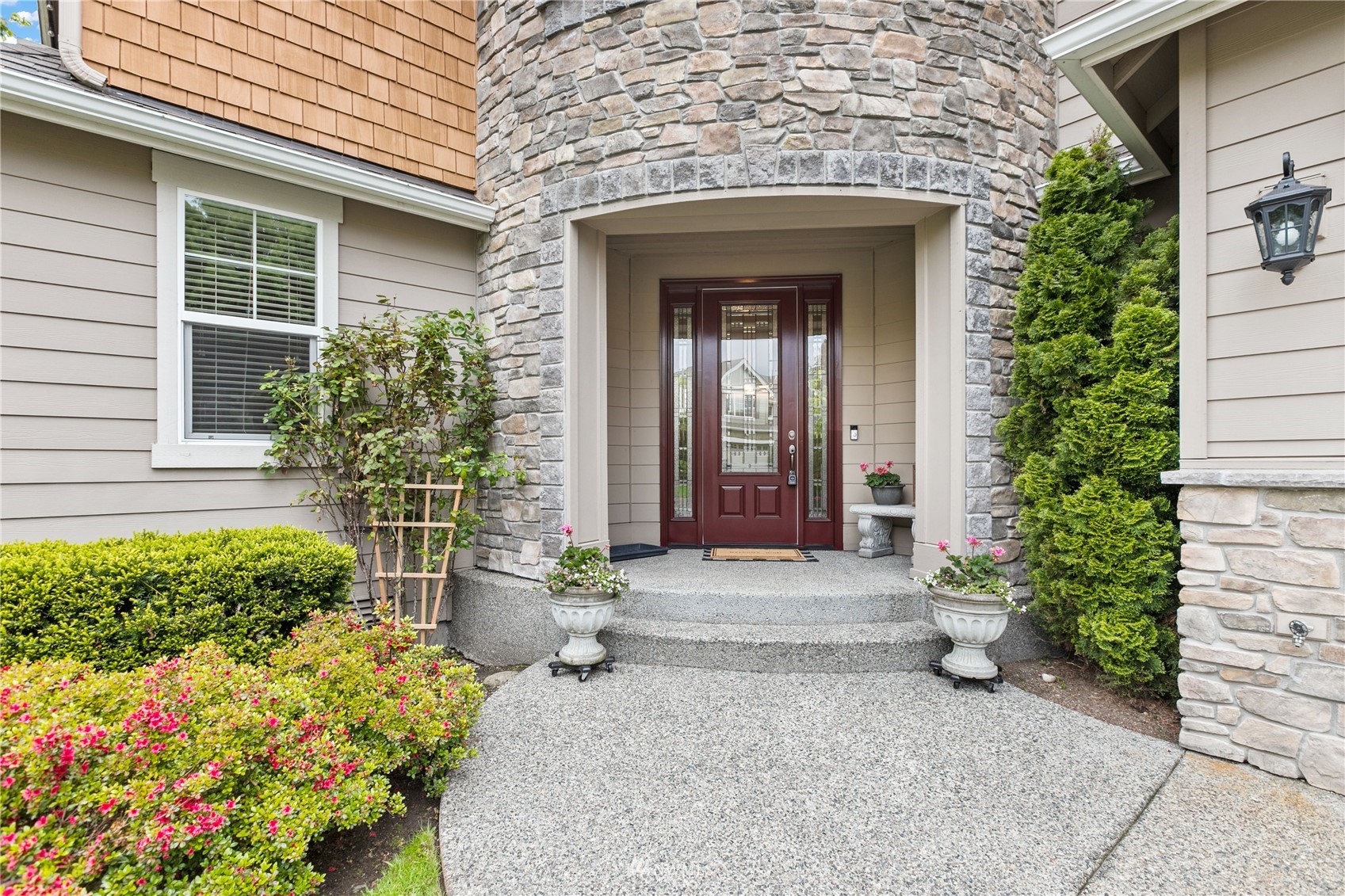 18407 36th Avenue Southeast Bothell, WA 98012 - Photo 2 of 39 a front view of a house with a yard and flowers