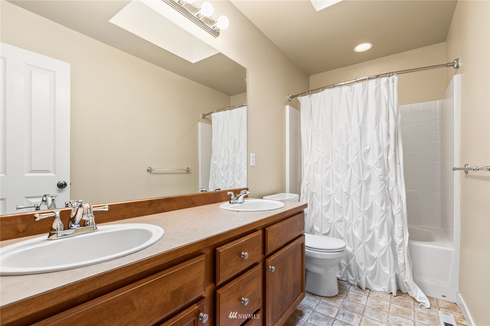 18407 36th Avenue Southeast Bothell, WA 98012 - Photo 27 of 39 a bathroom with a double vanity sink toilet and a mirror