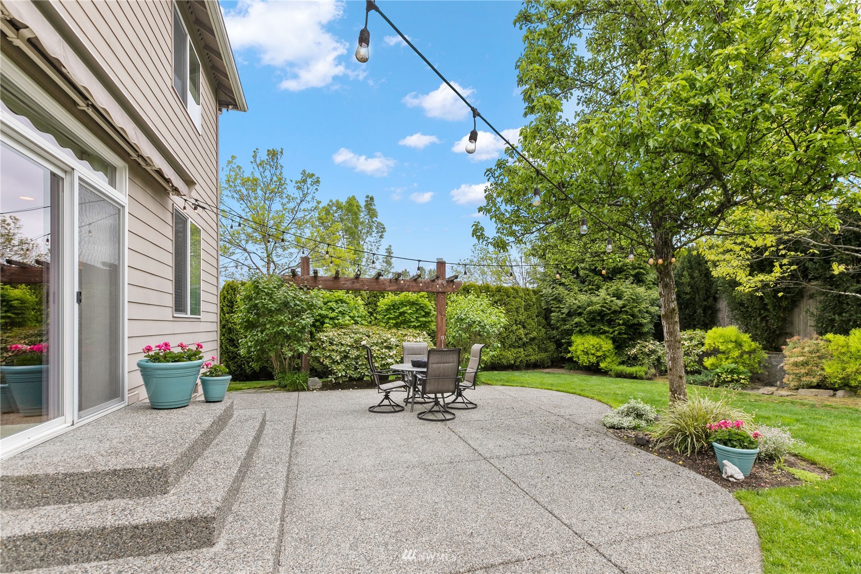 18407 36th Avenue Southeast Bothell, WA 98012 - Photo 31 of 39 a view of a chair and tables in the patio in front of a building